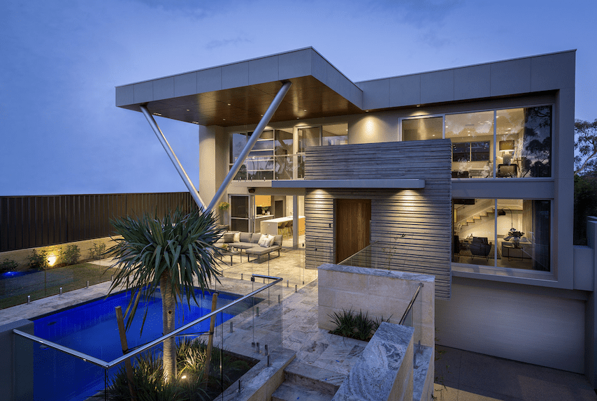 Exterior front view of luxury two story home with pool and architectural detail